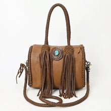 Load image into Gallery viewer, Reata leather barrel satchel in Caramel, front view with turquoise stone concho, braided handles, and long fringe
