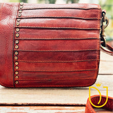 Load image into Gallery viewer, Close-up of the Washoe Lake crossbody flap showing star-stamped antique brass studs and layered stitched Italian leather pleats
