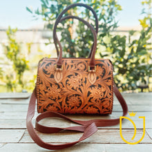Load image into Gallery viewer, Whitby hand tooled leather crossbody bag with floral carving, front view outdoors
