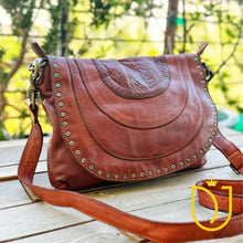 Load image into Gallery viewer, Venezia cognac Italian leather crossbody purse at an angle, showing studded flap and antique brass swivel clasp

