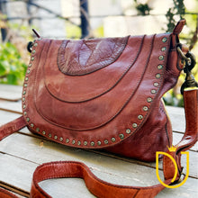 Load image into Gallery viewer, Venezia cognac leather crossbody purse from the opposite angle, showing hand-dyed leather tones and studded flap edge
