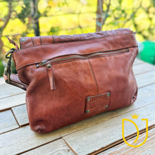 Load image into Gallery viewer, Venezia cognac leather crossbody purse back at an angle, showing zip pocket and antique brass hardware
