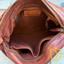 Load image into Gallery viewer, Inside the Venezia cognac leather crossbody purse showing canvas lining, interior zip pocket, and slip pocket
