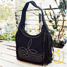 Load image into Gallery viewer, Onyx boot stitch suede hobo bag, angled view showing cream embroidery, buck-stitch edging and long fringe
