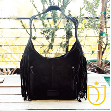 Load image into Gallery viewer, Onyx black suede hobo bag, back view with two vertical zip pockets and suede fringe on both sides
