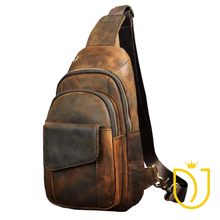 Load image into Gallery viewer, Drifter distressed brown leather sling bag, front view with flap pocket, two brass zip compartments, headphone port, and woven strap
