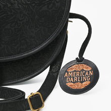 Load image into Gallery viewer, Close-up of Nightshade tone-on-tone floral embossing, leather trim and antique brass buckle
