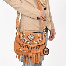 Load image into Gallery viewer, Lodestar suede fringe crossbody worn on the shoulder, embroidered flap and tassel in detail
