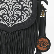 Load image into Gallery viewer, Close-up of the Raven bag's white scroll embroidery, pebbled black leather, and leather fringe
