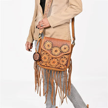Load image into Gallery viewer, Solana tooled sunflower crossbody worn on the shoulder, fringe and tooled strap in detail
