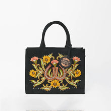 Load image into Gallery viewer, Front view of the Lady Luck tote with embroidered horseshoes, sunflowers, coral blooms and studs
