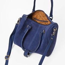 Load image into Gallery viewer, Lockhart navy suede Western speedy bag with NFR embroidered patch and rolled handles. A navy blue suede handbag with gold-tone hardware, shown open to reveal a tan patterned interior lining. The bag features dual top handles, a detachable shoulder strap, and zippered compartments.
