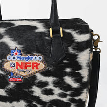 Load image into Gallery viewer, Tuff black and white hair-on cowhide speedy bag with PRCA patch and NFR charm
