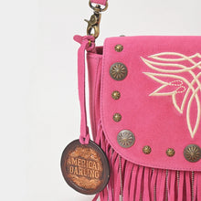 Load image into Gallery viewer, Close-up of the pink Sparrow purse's boot-stitch embroidery, brass conchos, star studs, and ball-chain fringe on suede
