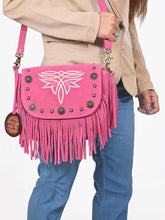 Load image into Gallery viewer, Close-up of a woman wearing the pink Sparrow suede fringe crossbody with chain fringe and suede tassel
