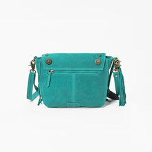 Load image into Gallery viewer, Back view of the turquoise Sparrow suede crossbody purse with exterior zip pocket, brass conchos, and side tassel
