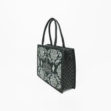 Load image into Gallery viewer, Side view of the Lacey embroidered leather tote showing the diamond-quilted side gusset and zip top
