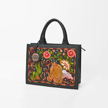 Load image into Gallery viewer, Liberty embroidered leather western tote bag, angled front view, black pebbled leather with chain-stitch horse, saguaro, red and pink flowers, American flag, lariat border, and rhinestone studs
