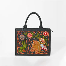 Load image into Gallery viewer, Liberty embroidered leather tote, straight front view showing the full horse, cactus, floral, and flag embroidery panel framed by a looping rope border
