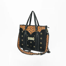 Load image into Gallery viewer, Fandango hand-tooled hair-on leather fringe tote, angled side view showing whipstitched edges, braided handles, and detachable hand-tooled strap
