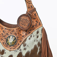 Load image into Gallery viewer, Close-up of Appaloosa's hand-carved floral tooling, tooled handle and cactus-and-sunrise concho
