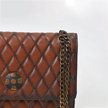 Load image into Gallery viewer, Close-up of Sorrel's diamond quilting, vintage concho and bronze curb chain
