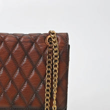 Load image into Gallery viewer, Close-up of Bourbon's diamond quilting, burnished cognac finish and antique gold curb chain
